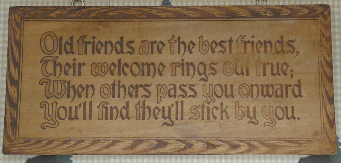 a wall mount with text carved in with pyrography